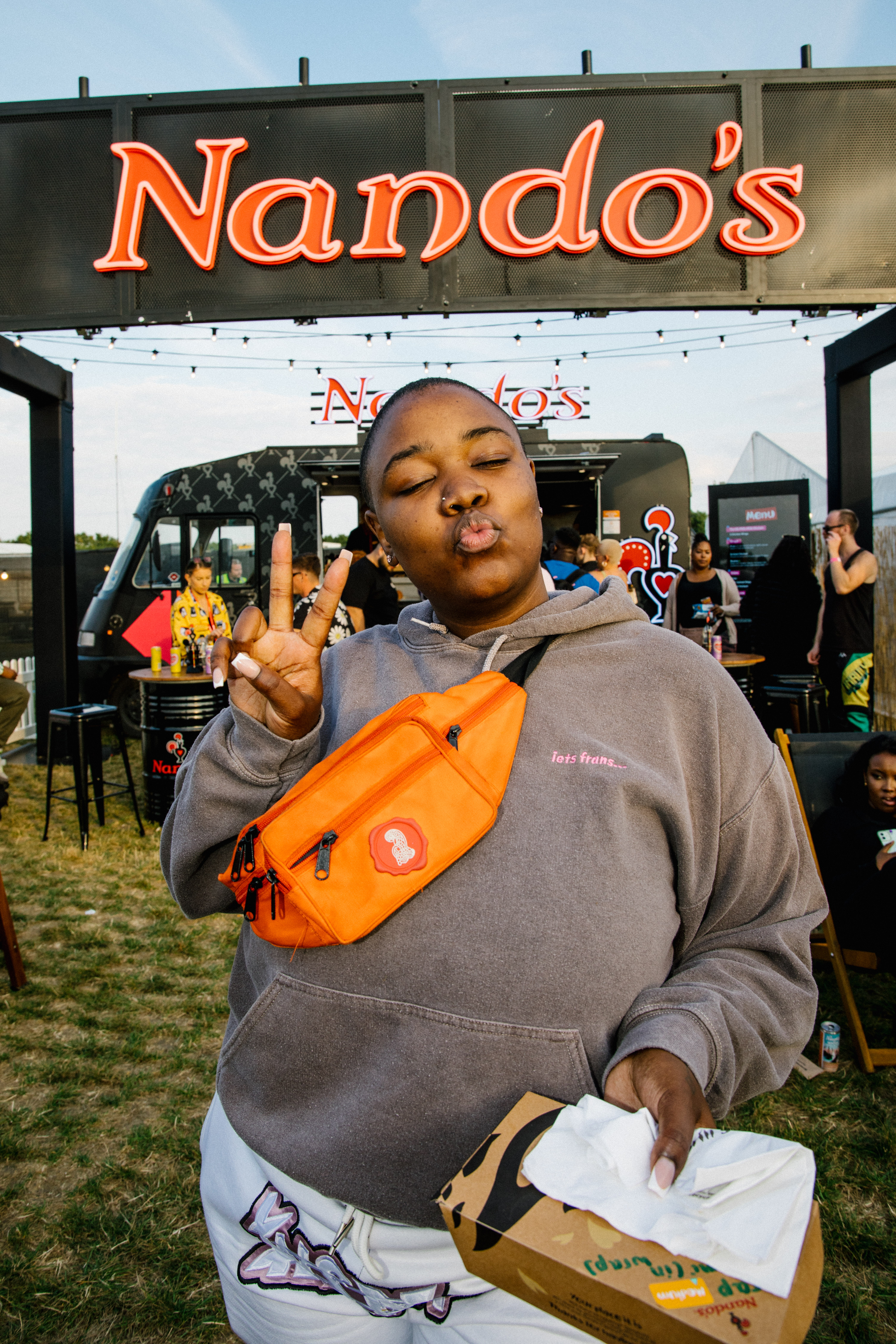 Singer songwriter Hamzaa backstage on Day One at Strawberries and Creem Festival, caught re-fuelling on some Nando’s PERi-PERi between the festivities